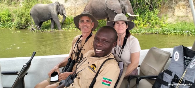 Our luxury clients happily pose for a photo during a boat cruise in the Nile river in Murchison falls