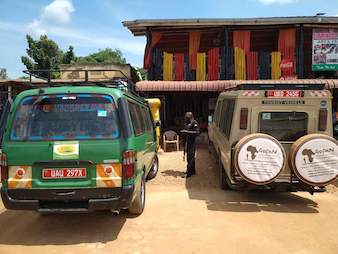 Our Safari van and Landcruiser parked at Flamingo a famous lunch spot at the equator in Kayabwe, Uganda