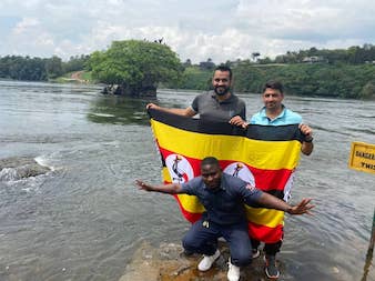 Tourists led by our guide are posing for a photo at the source of river Nile in Jinja