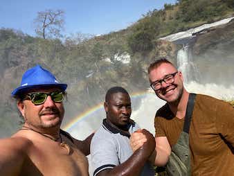Tourists soaked by falls water at the top of Murchison falls, Uganda