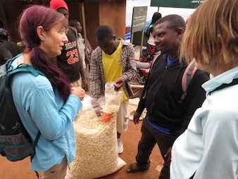 Tourist Beverly interacting with local people in the market along the shores of Lake Bunyonyi, Uganda